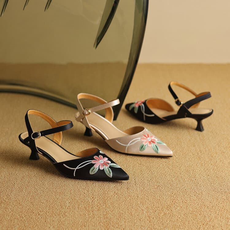 A pair of stylish women's shoes with floral embroidery and a pointed toe design, perfect for fashionable occasions. Available in black and beige at Monalisa Store.