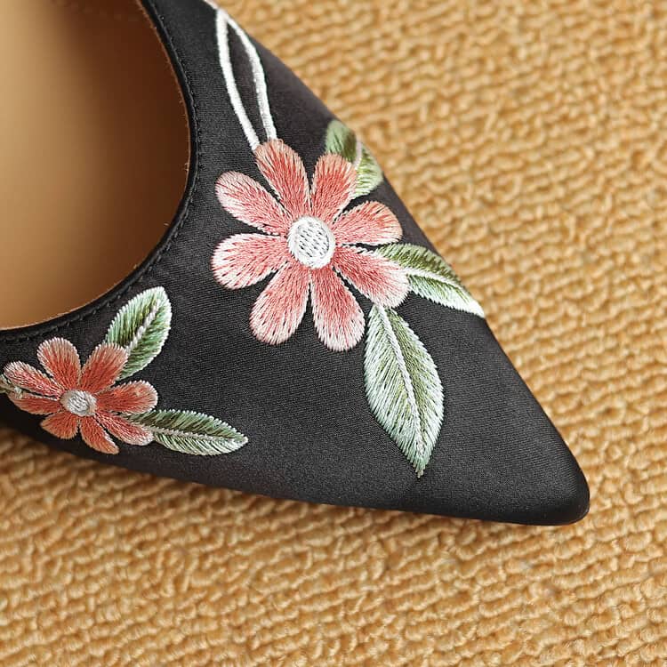 Beautiful black embroidered shoe with pink flowers and green leaves, perfect for special occasions. Premium quality, stylish design, ideal for fashion-forward women seeking comfort and elegance.