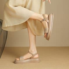Comfortable beige women's sandals with adjustable ankle straps and thick soles, perfect for everyday wear and stylish comfort.