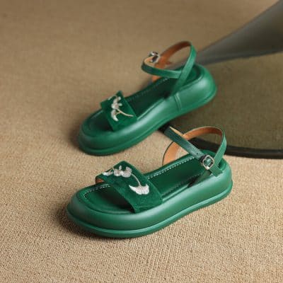 Vibrant green platform sandals featuring embroidered floral embellishments and adjustable ankle straps, ideal for adding a fashionable touch to any casual look.