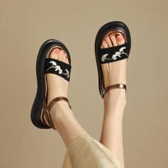 Fashionable women's sandals with trendy black and metallic accents, featuring embroidery detail, perfect for casual or summer wear.