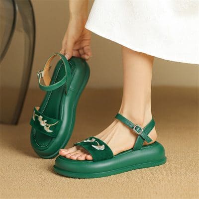 Comfortable green platform sandals with ankle strap and embroidered bird details, perfect for fashionable women seeking trendy and supportive footwear.