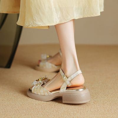 Comfortable women's platform sandals with ankle straps and decorative embellishments, perfect for fashion-forward looks.