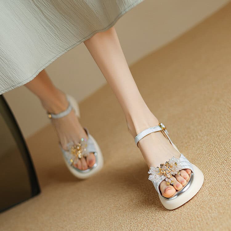 High-quality white sandals with intricate flower design and sparkling embellishments, perfect for fashionable appointments at Monalisa Medical optical store.