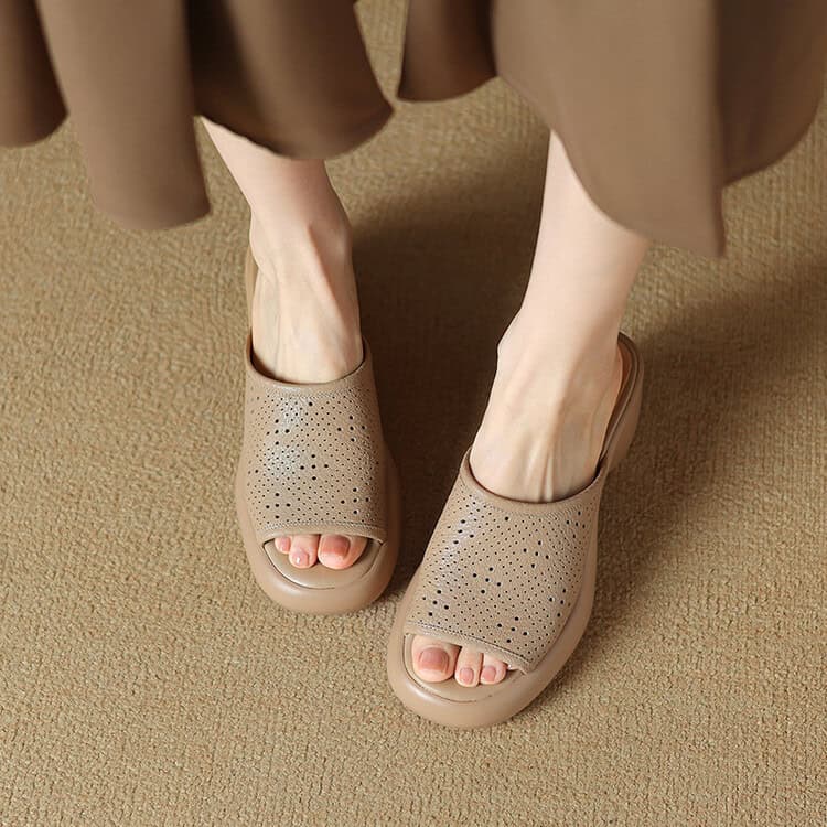 Relaxing beige slip-on slippers with perforated design, perfect for indoor use, providing comfort and support for everyday wear.