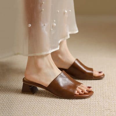 Stylish brown leather sandals with pearl accents, perfect for enhancing your fashion statement and comfort. Ideal for casual or dressy occasions.