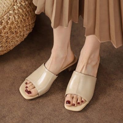 Comfortable beige slide sandals showcasing elegant design, perfect for casual or dressy occasions. High-quality materials ensure durability and comfort.