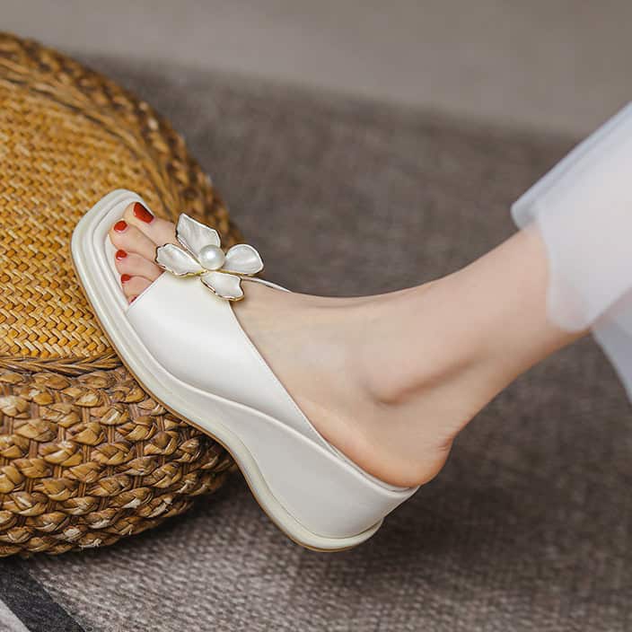 Comfortable white slippers with decorative flower and pearl embellishments for women, perfect for casual wear and home comfort.