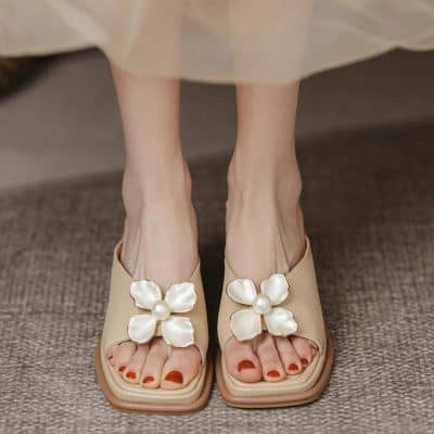 Elegant beige sandals with large pearl flower embellishments, perfect for summer and casual wear. Comfortable, stylish footwear from Monalisa Store.