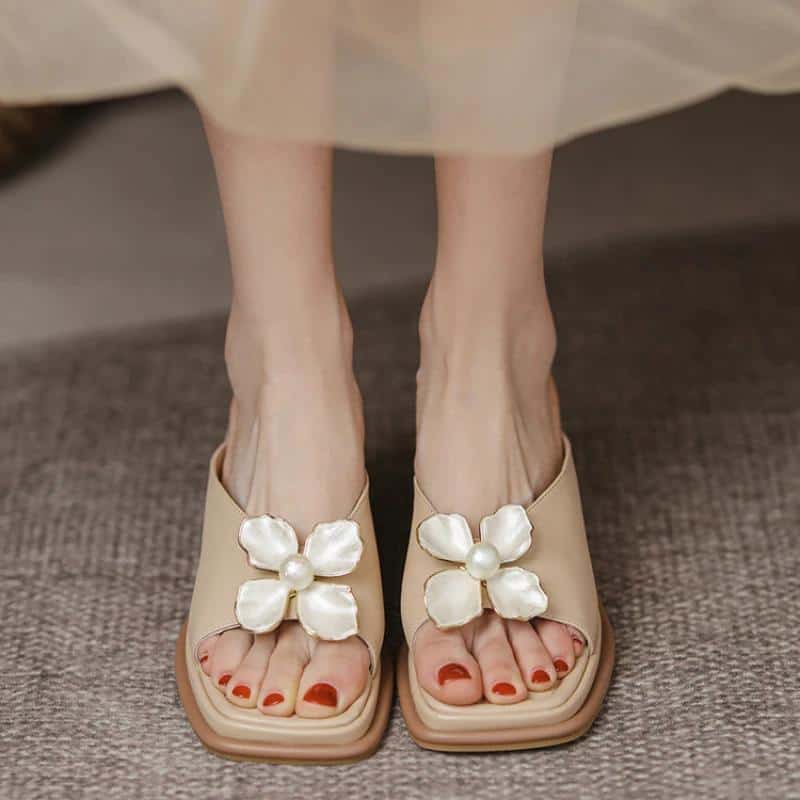 Elegant beige sandals with large pearl flower embellishments, perfect for summer and casual wear. Comfortable, stylish footwear from Monalisa Store.