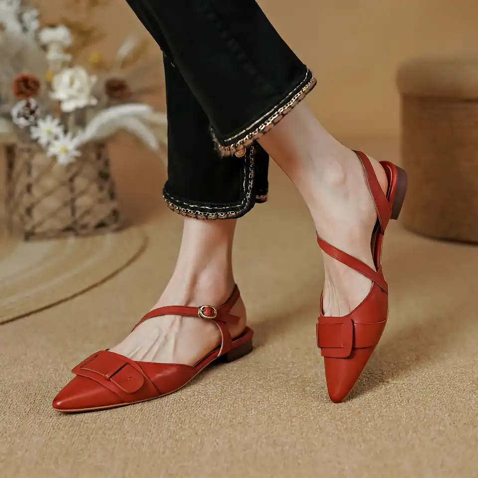 Elegant red women's pointed flats with ankle strap and bow detail for fashionable comfort. Perfect for casual or dressy occasions, blending style and functionality.