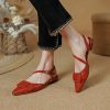 Comfortable women's fashionable red pointed-toe flats with adjustable ankle strap, perfect for stylish everyday wear or special occasions.