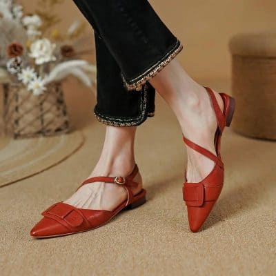 Comfortable women's fashionable red pointed-toe flats with adjustable ankle strap, perfect for stylish everyday wear or special occasions.
