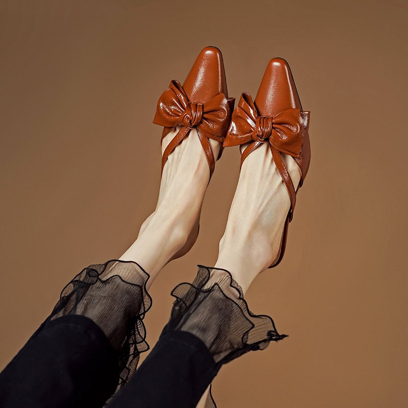 Elegant brown shoes with bow detail, perfect for fashion-forward women's footwear.