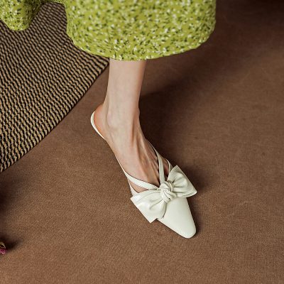 Comfortable white flats with large satin bow, perfect for stylish women and suitable for various occasions.