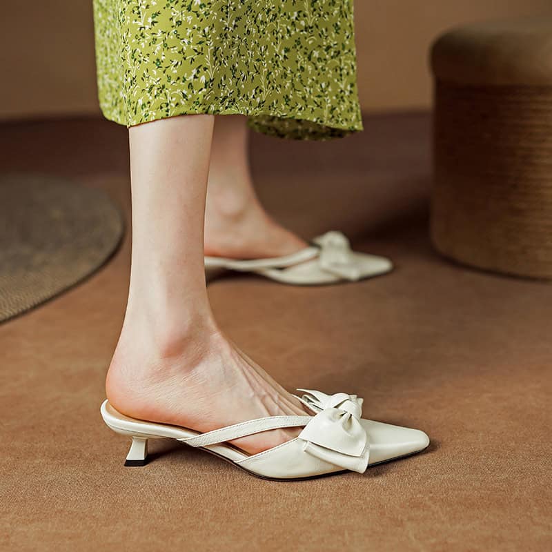 Olive green floral dress with white bow shoes, stylish and comfortable footwear perfect for casual or formal occasions.