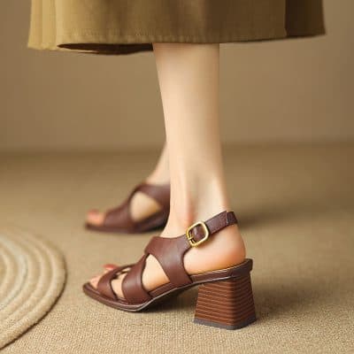 High-quality brown leather sandals with a sturdy block heel, adjustable ankle strap, and open toe design, perfect for stylish and comfortable footwear.