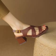 Elegant women's sandal featuring brown leather straps and a buckle closure, perfect for enhanced comfort and style in summer footwear collections.