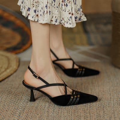 Stylish black strappy pointed-toe heels with a unique heel design, perfect for fashion-forward women. Ideal for formal occasions, parties, or stylish outings.