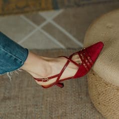 Fashionable red leather high-heeled shoe with stylish straps and gold accents, perfect for women seeking trendy footwear. Ideal for dressing up any outfit with sophistication and charm.