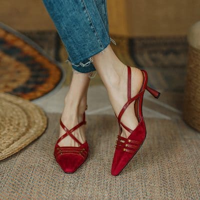 Elegant red high heels with pointed toes, ankle straps, and gold accents, perfect for fashion-forward women. Comfortable and chic footwear for special occasions and daily wear.