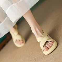 Close-up of a woman's feet wearing fashionable beige sandals from Monalisa Store, perfect for trendy and comfortable footwear options.