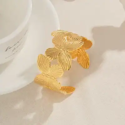 Elegant butterfly-shaped gold bracelet with intricate leaf pattern design, perfect for women’s jewelry collection, stylish accessory for all occasions.