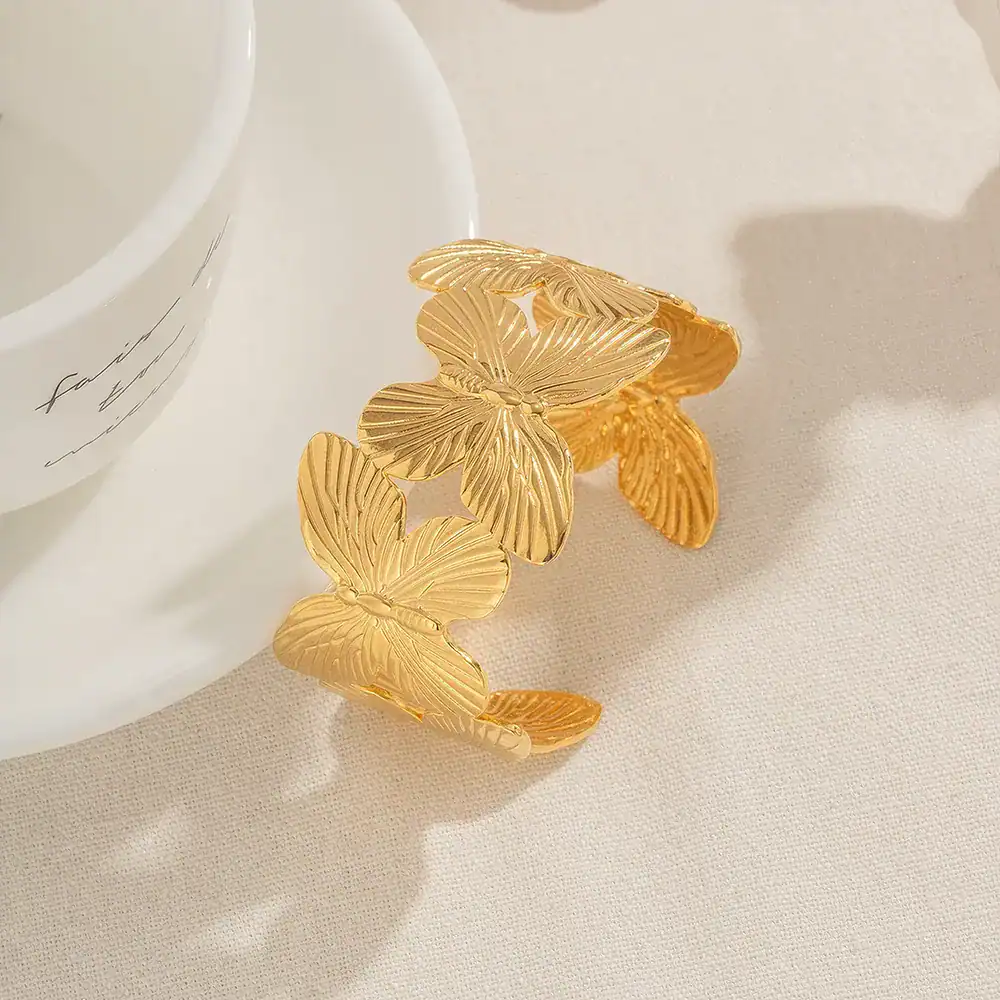 Elegant butterfly-shaped gold bracelet with intricate leaf pattern design, perfect for women’s jewelry collection, stylish accessory for all occasions.