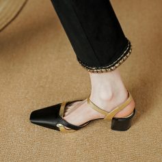 Elegant women's high heel shoe with black and gold accents, perfect for fashion-forward occasions. Features pointed toe and ankle strap for a chic, sophisticated look.
