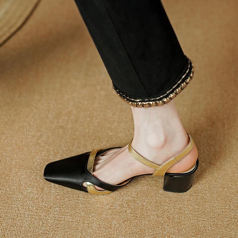 Elegant women's high heel shoe with black and gold accents, perfect for fashion-forward occasions. Features pointed toe and ankle strap for a chic, sophisticated look.