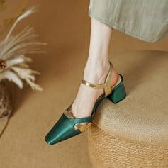Elegant women's high heel shoe featuring green and gold design perfect for formal and stylish occasions.