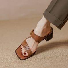 Elegant brown leather sandals for women, featuring a comfortable block heel, adjustable ankle strap, and fashionable design perfect for everyday wear or special occasions.
