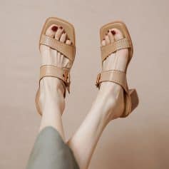 Pair of beige fashionable sandals with chunky heels and adjustable straps, perfect for summer or casual wear.