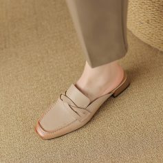 Comfortable beige leather shoe with lace-up design and block heel, suitable for professional and casual settings, offering style and support for all-day wear.