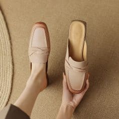 Close-up of stylish nude leather loafers displayed on a beige textured surface, showcasing handcrafted design and comfort, perfect for fashionable women seeking premium footwear.