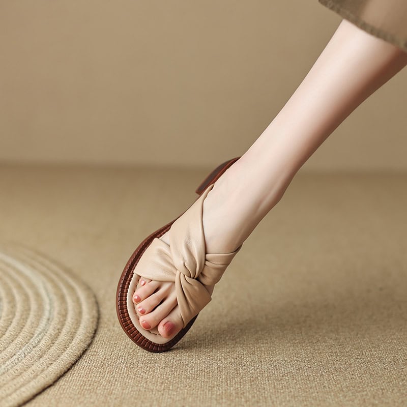 Comfortable beige toe-loop sandal with knotted design, perfect for casual or summer wear. Features a soft strap, durable sole, and elegant look suitable for daily fashion.