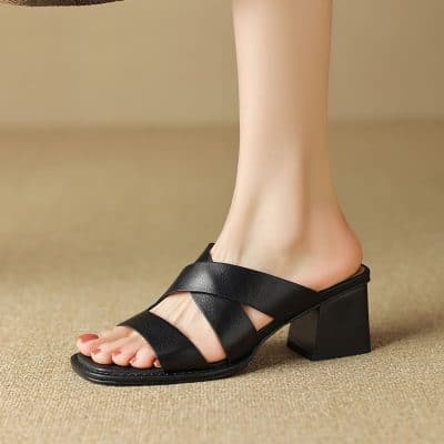 Elegant black leather open-toe sandal with a chunky heel, designed for women seeking comfort and style. Ideal for daily wear, work, or special occasions.