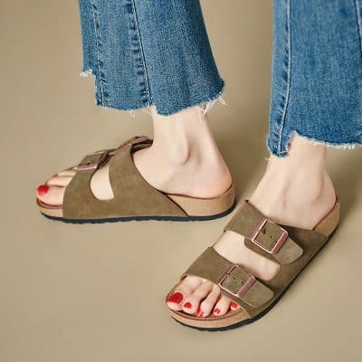 Comfortable casual women’s sandals featuring dual buckle straps, cork soles, and suede material for everyday wear and trendy foot fashion.