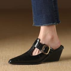 Elegant black wedge shoe with gold buckle, perfect for fashionable women seeking comfort and style in their footwear.