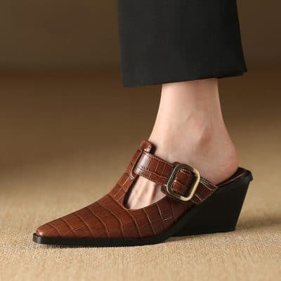 High-quality brown wedge women's shoe with crocodile texture, adjustable buckle, perfect for fashion-forward looks and comfort. Ideal for office wear or casual outings.