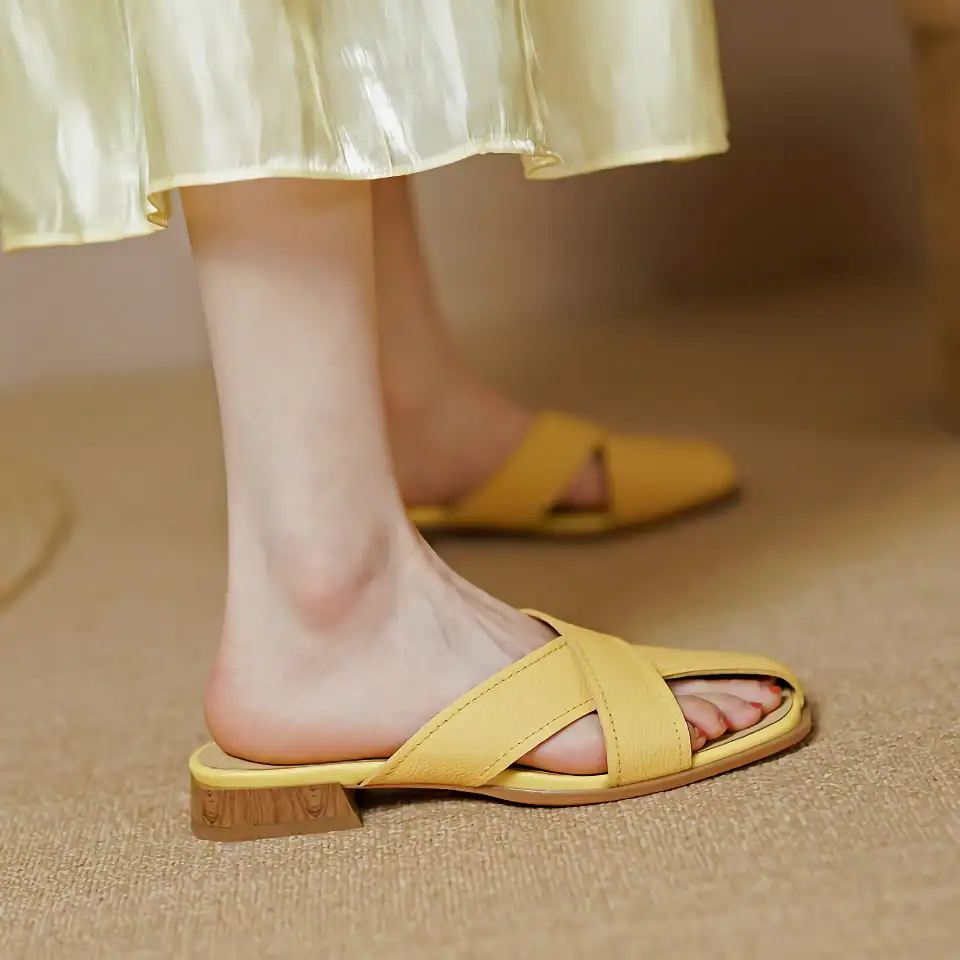 Comfortable yellow slip-on sandals with block heels perfect for casual and chic outfits.
