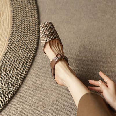 Elegant brown leather sandal with buckle, stylish and comfortable for outdoor wear.