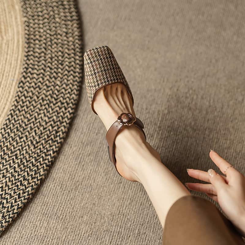 Elegant brown leather sandal with buckle, stylish and comfortable for outdoor wear.