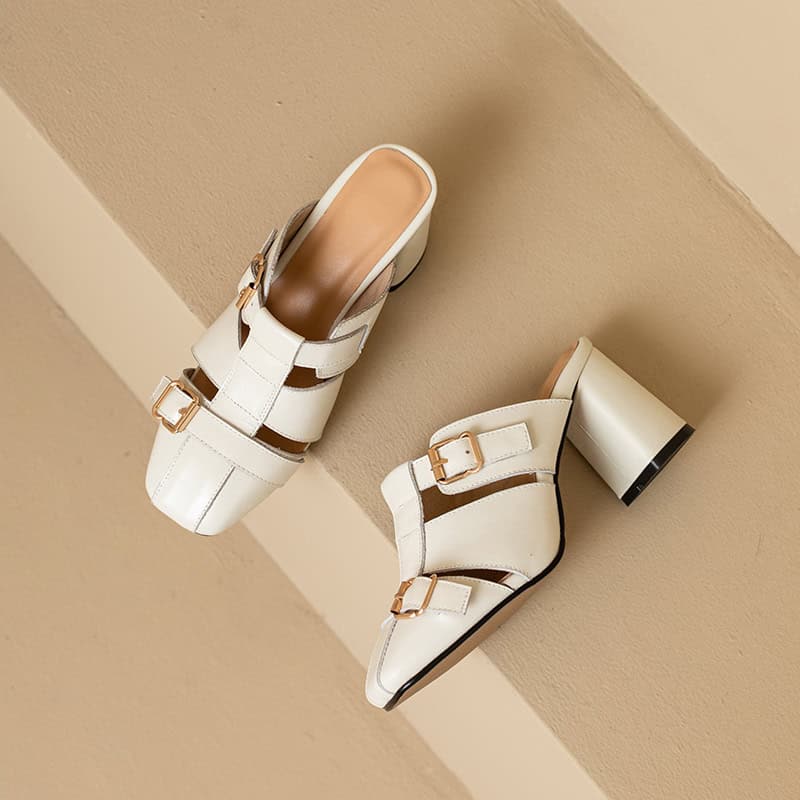 Elegant white heeled sandals with buckle details, perfect for fashion-forward women. Ideal for dressing up or casual outings, combining comfort with chic style.