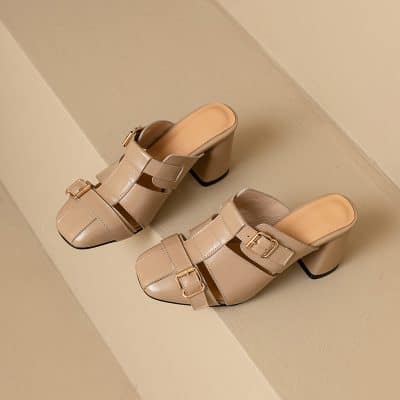 Luxurious beige women's slip-on heels with decorative buckles, ideal for fashion-forward looks. Designed for comfort and style, these chic shoes are perfect for both casual and formal events.