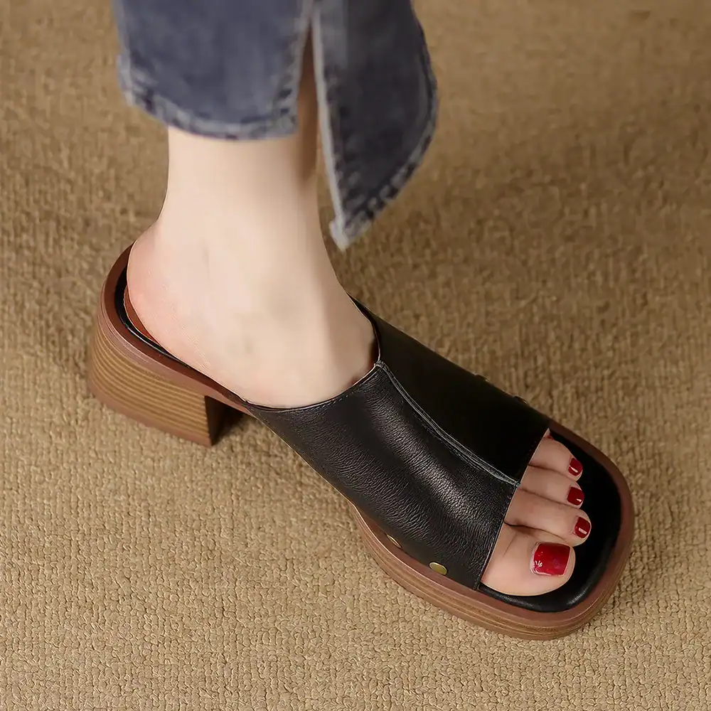 Stylish black leather open-toe sandal with chunky heel, perfect for women seeking comfort and fashion. Ideal for casual or semi-formal occasions, blending style with support.