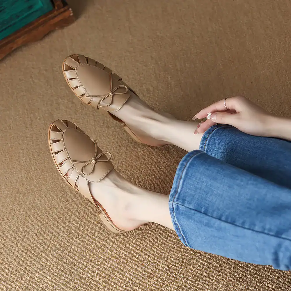 Comfortable beige ballet flats with bow accents for women, ideal for casual outings and stylish daily footwear.