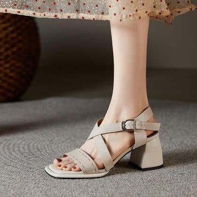 Elegant beige high heel sandal for women, featuring adjustable ankle strap and block heel, perfect for fashion-forward looks and special occasions.