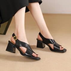 Stylish black leather sandals featuring a block heel and adjustable strap, perfect for women seeking comfortable and fashionable footwear in eye care or optical shop settings.