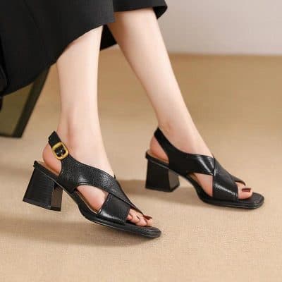 Stylish black leather sandals featuring a block heel and adjustable strap, perfect for women seeking comfortable and fashionable footwear in eye care or optical shop settings.